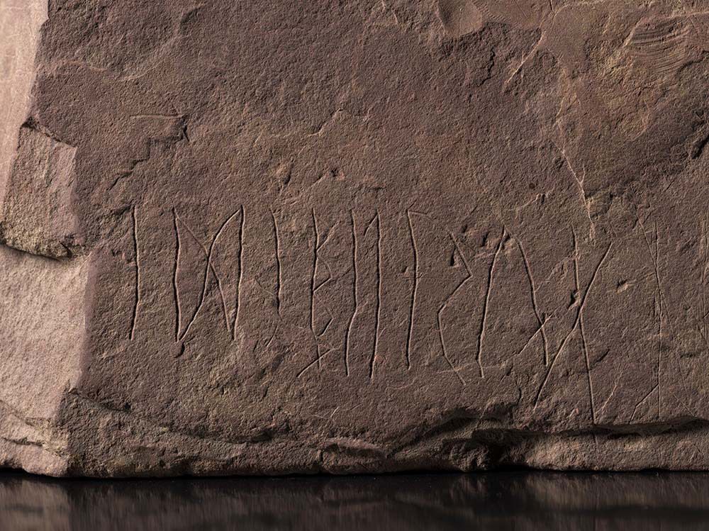 Close up of a stone with rune inscriptions