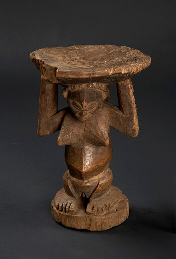 (UEM15020) Luba thrones are sophistically carved wooden seats fashioned in the shape of female figure supporting a circular seat. The Luba thrones symbolise authority and spiritual connection to ancestors. These are ceremonial stools, sculpted in the form of female figures, and are not intended for practical seating. The thrones are receptacles for the chief’s spirit, and a seat for meetings between the ruler, the people and the spirit world, including the ancestors. The human-like form of the ceremonial stool depicts a female figure indicating women as bearers of sacared knowledge, spiritual authority and the perpetuation of lineage and royal memory. The Luba refer to their thrones as lupona, kioni or kipona . Material: Wood  Region: Kasai-oriental, Sankuru, Luba Height: 32 cm. Arrival: Donated to the Museum by Dr Inge Heiberg, 1905.