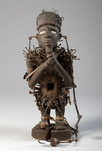 (UEM21037)&amp;#160;Power figure in the form of a male character. The term used to refer to this kind of spiritual objects in Congo is Nkisi/Minkisi . Power figures embody spiritual power, which is controlled and, when needed, activated by a healer and ritual specialist to obliterate affliction and any other kind of threat to social harmony and well-being. The creation of a power figure needs close cooperation between a woodcarver and a ritual specialist. The woodcarver sculpts a human-likefigure, and then the ritual specialist ( Nganga ) transforms the wooden sculpture into a Nkisi by imbuing it with spiritual potency and decoration befitting its incorporeal capacity. This Nkisi is wearing a hat; its chest, back, and lower parts are covered with nails, and the tummy has a protruding box that initially held a mirror meant to reflect any wickedness sent in its direction. The iron nails embedded in the human-like figure release ancestral and spiritual power as they are hammered into the Nkisi . The Nkisi is intended to be hung from the attached iron chains. Material: Wood, iron Region: Kasai Oriental, Ibembo Height: 60 cm. Arrival: Donated to the Museum by Dr Inge Heiberg, 1911.