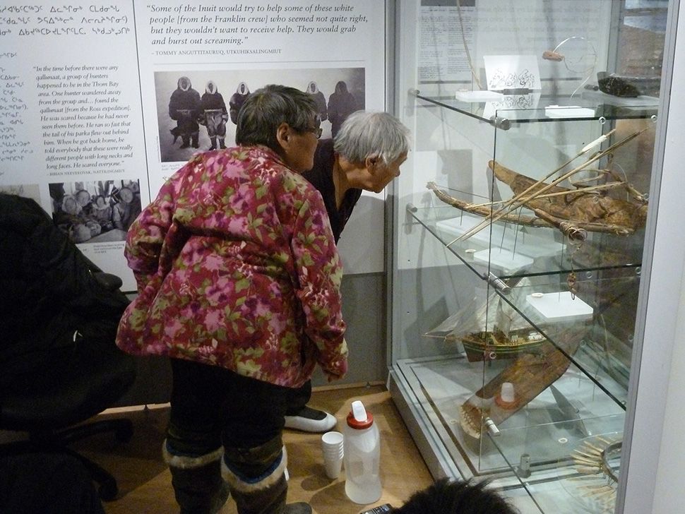 Elders Marie Anguti and Maria Niptayuk studying objects from Amundsen’s Gjoa Haven collection at the Nattilik Heritage Centre, Gjoa Haven, April 2015
