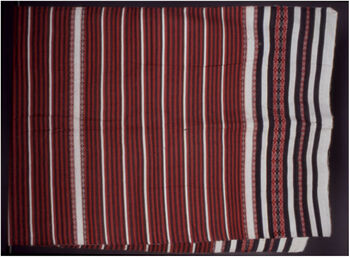 (UEM46988) Ribi gaseng is draped over the upper body over a sari blouse. Below, Ege, (assamese Mekhela), a long skirt, is worn. It is primarily used for social occasions, celebrations, and rituals, yet later, when worn, for everyday wear. Woven by Nirada Mili. Material: Cotton. Mising, Assam, Majuli, Kamalabari districts.