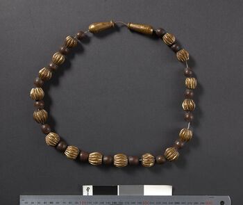 (UEM46961) Gold imitation. Ser means gold and lek means necklace in Karbi. Gold-plated (painted) hand-carved wooden beads. Worn by the bride at the wedding. It can be used on several special occasions as well. Karbi Anglong/Hamren/Ronghang Rongbong districts.