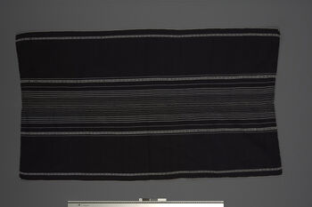 (UEM46844) Woven using a loin loom, warp faced weave with pick-up pattern edging. Woven in two lengths and sewn together in the middle. Used by women for everyday use, parties and rituals. It is fastened with a wamkok belt that is tied around the waist. Hamren, West Karbi Anglong.