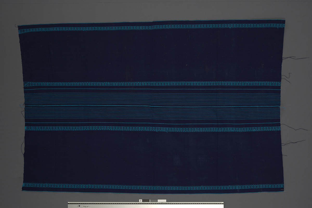(UEM46846) Woven using a loin loom, warp faced weave with pick-up pattern edging. Woven in two lengths and sewn together in the middle. Used by women for everyday use, parties and rituals. It is fastened with a wamkok belt that is tied around the waist. Material: Acryl.