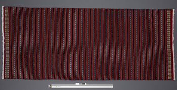(UEM46875) Floor loom, plain weft faced weave. Used as shawl on cold days but can be draped as a pehseleng as well. Material: cotton (warp), cashmilon acryl (weft).