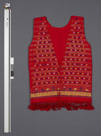 (UEM46896) Floor loom, plain weave with mixed technique for patterns and motifs. For daily use. A local attempt to make “modern” clothes based on traditional patterns and motifs. 1990's. Worn by young girls together with skirts or trousers. Material: Acryl.