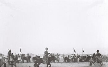 In the photograph, we see Bogd Khaan and his silk-draped carriage arriving, surrounded by mounted monks. Mongols kneel in worship of their new religious and political leader. Behind Bogd Khaan came a similar carriage escorting his wife, Tsendiin Dondogdulam (Ekh Dagina), now queen and goddess.