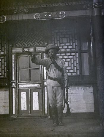 (UEMf09893_036) This photograph was captured in February 1913, when several Inner Mongolians came to Urga, 'running round this town making all kind of trouble'. A few months earlier, the Mongolian government had signed a treaty with Russia that excluded Inner Mongolia from the country, crushing every hope that Inner Mongolians had of becoming part of Mongolia. Mamen wrote in his diary that they were dissatisfied and caused all kinds of trouble around town. Mamen and Lobsan dressed up with weapons and photographed themselves, the caption reads: 'ready for war'. The border from the 1912 treaty still exists today, separating China and Mongolia. Inner Mongolia is today a province in China, housing almost twice as many Mongolians as within Mongolia.