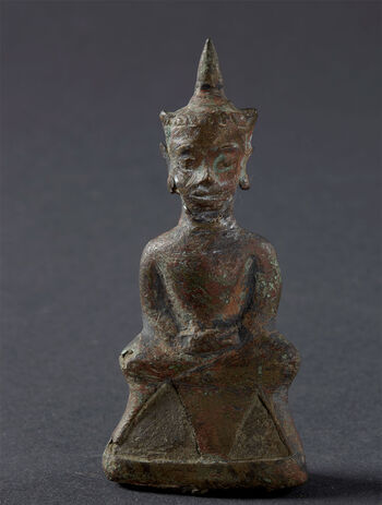 (UEM1270) Description: "A Buddha from Cape Negrais near Bassein in Burma, from an idol temple. Burma" (Translation from the original Norwegian catalog card). Classification: Figure, representation of gods and spirits. Material: Gold (metal), bronze (metal). Height: 9.1 cm. Width: 4.2 cm. Collection history: Delivered by First Officer John Gulbrandson.