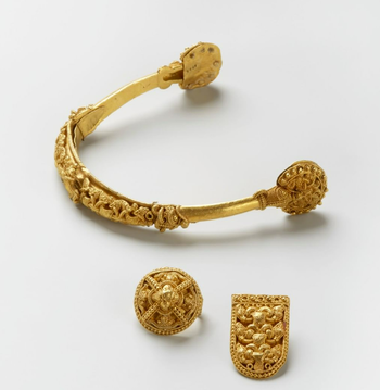 The gold spur from Rød is among the most spectacular of all artefacts from the Viking Age in Norway, and is the only one of its kind in Scandinavia. It is covered with intricate patterns in filigree gold bead thread and soldered gold grains and depicts animals and patterns in the Viking Age Borre style. The work is incredibly detailed. It was probably made by a Scandinavian jeweller in the last half of the 10th century. The spur was found in 1872 on the farm of Rød in Rygge during ploughing, together with a gold fitting. 45 years later, a second fitting was discovered in the same field. No trace of a grave was found, and the other spur has never been found. See the objects in the exhibition VÍKINGR. C5905, C5906, C22406.