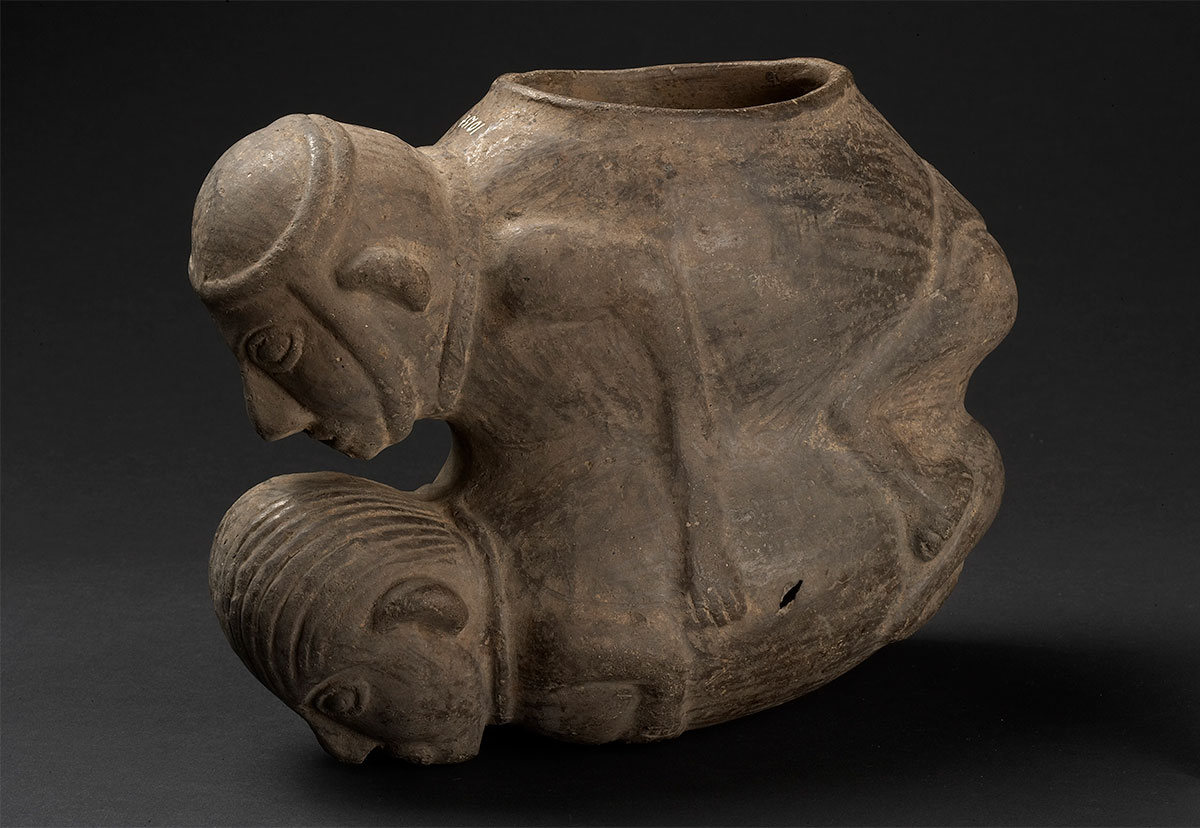 (UEM10154) Bowl in form of a copulation scene of two humans. Mold made. Smudge fired black ware. Chimú, 1000–1470, Peru.