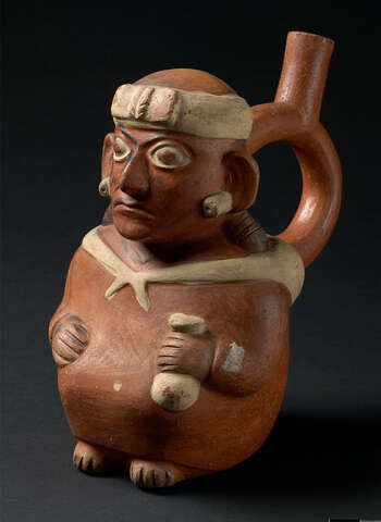 (UEM9975) Bottle in the form of a man sitting in a squat. He wears a head band with a bow on the forehead, braids on both sides, and tubular earplugs. The face painting consists in a black chevron on both cheeks and a black line surrounding eyes, nose, mouth and on the neck. In his left hand he holds a lime container, used for chewing coca. He wears a sling on the back. Mold made. Polychrome painting reddish brown (spout, body), white (headband, earplugs, sling and lime container), brown braids), black (face painting). Moche, 100–800, Peru.