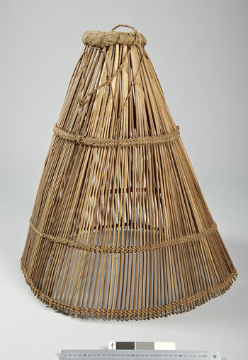(UEM20873)&amp;#160;Rev. Bodding’s notes: 'Fish trap, egg-shaped, made of bamboo sticks, held together by 3 rows of twined rope, opening also in front. Inserted in the mud and fish taken out through the small opening.' Material: Bamboo, fibre (unknown), fabric (unknown). Length: 66 cm, diameter: 61 cm.