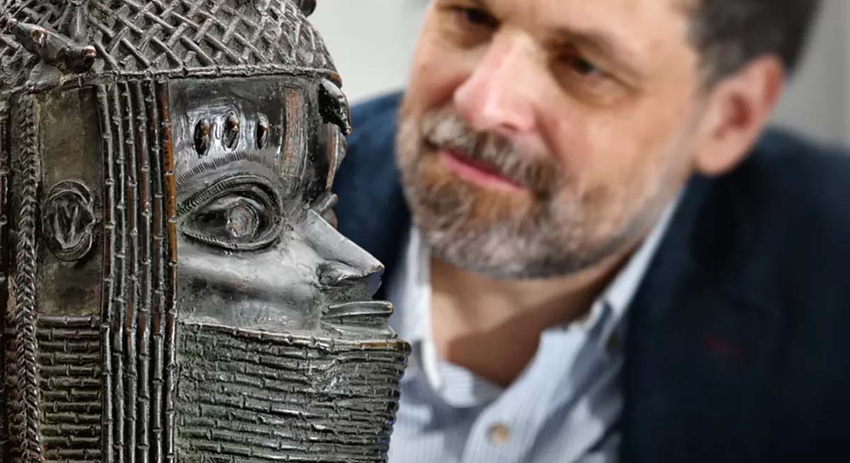 Close up of a man looking at a statue.