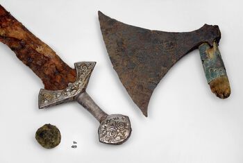 The objects found in&amp;#160;grave 8 at Langeid&amp;#160;- sword, axe, two coin fragments and a large ball of pitch. Photo: Vegard Vike, KHM/UiO.