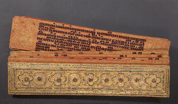 (UEM48895) Description: Text plate (Pali manuscript) from Burma. Classification: Arts and Crafts/Scripting. Material: wood, glass (amorphous solid), lacquer, gold (metal), metal. Dimensions: Length: 56.5 cm. Width: 12 cm. Thickness: 4.5 cm. Collection history: Gift of Hjördis Sherry.