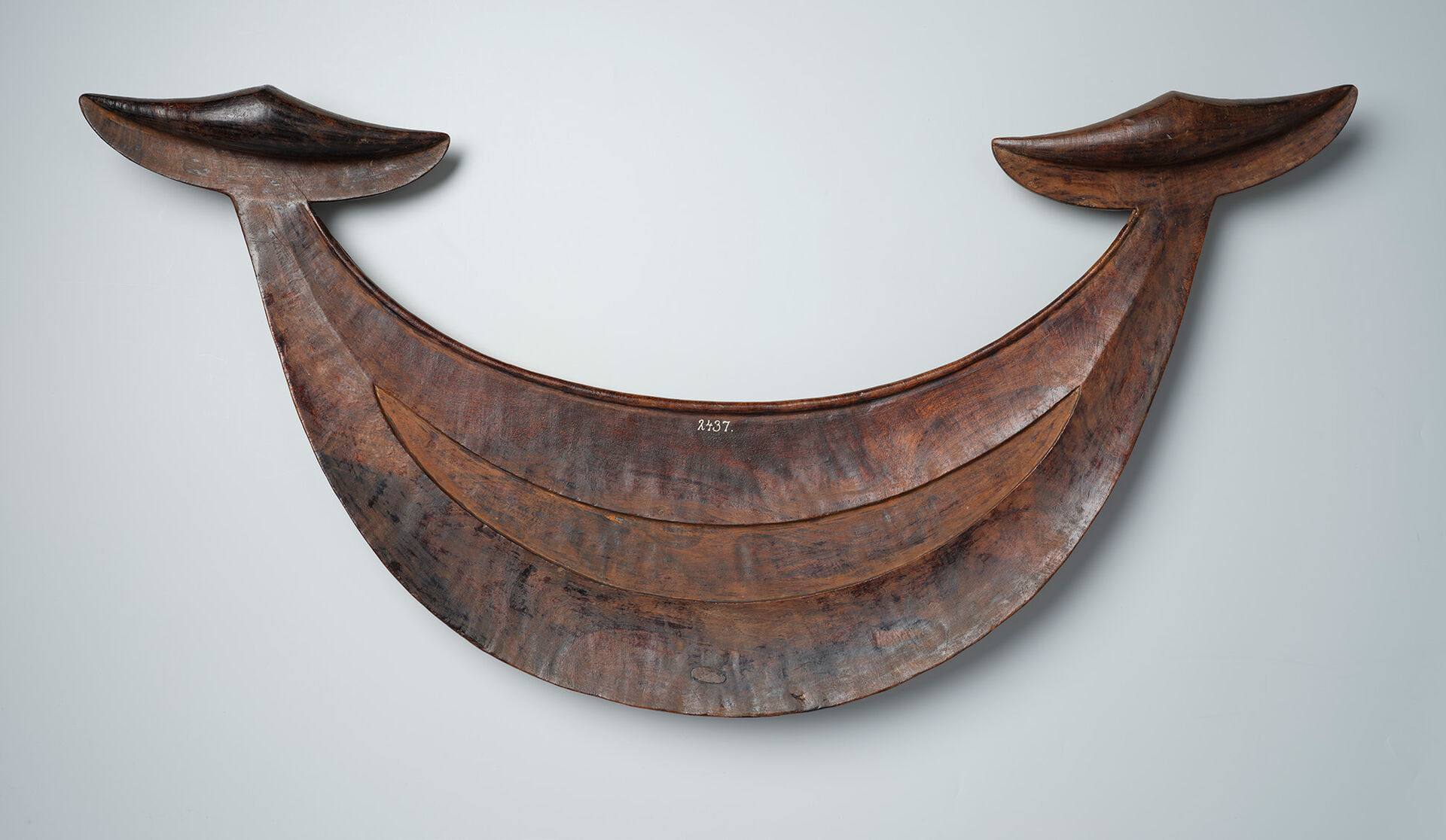 Reimiro breast ornament carved in brown hardwood